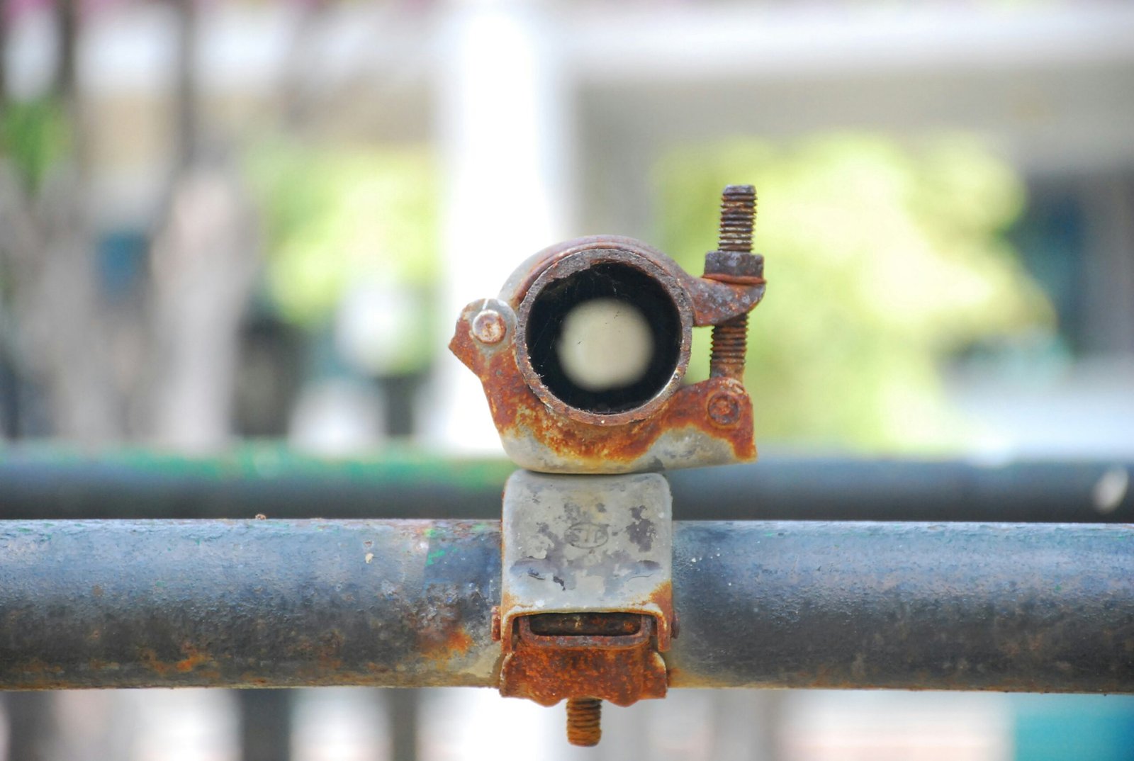 a rusted metal pipe with a hole in it